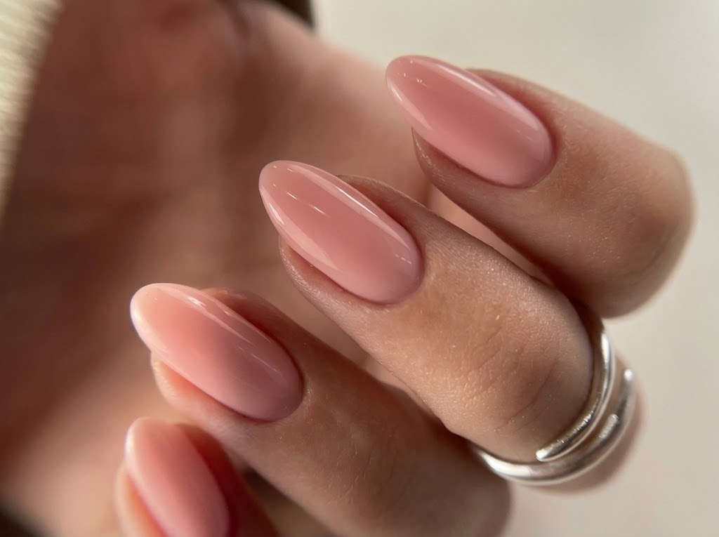 Glossy nude pink almond Russian manicure with precise cuticle detail at Eva Beauty in Centennial